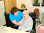 Here Francis love's on a resident of a care center. Marilyn plays piano from the Sonshine Songbook in the background.